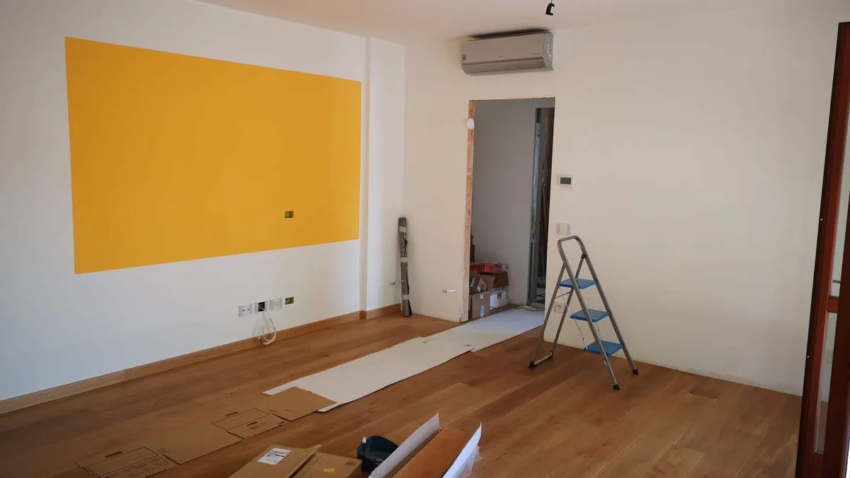 Room renovation featuring hardwood flooring and newly finished walls